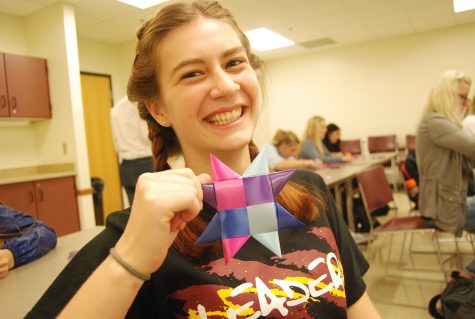 Star weaving veteran and sophomore Grace Golden grins as she shows off her first star of the day.  