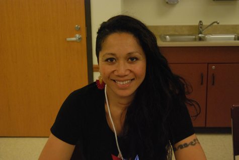 Artist Maryann Talia Pau takes a break from helping students and poses for a portrait during a One Million Stars to End Violence tutorial workshop session, led by Mrs. Smith. 