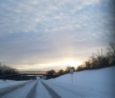 A picture of the sky and bridge in the snow near Arlington Elementary School and Kroger.