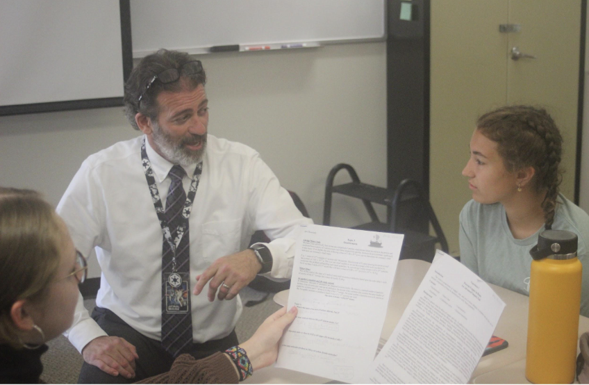 Mr. Blackburn discusses material with Kate Paflas (11) in his classroom.