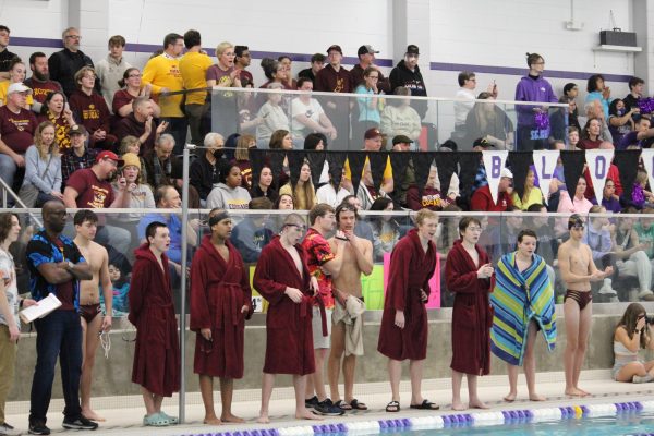 The boy swim team cheers on their teammates at a meet last winter.