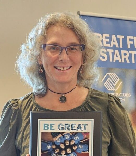 Bloomington High School North teacher Dani Ansaldo displays her "Be Great" award Friday, August 15, 2025, in Bloomington, Ind. Ansaldo was recently honored with the club’s “Be Great” award for her work empowering young women.