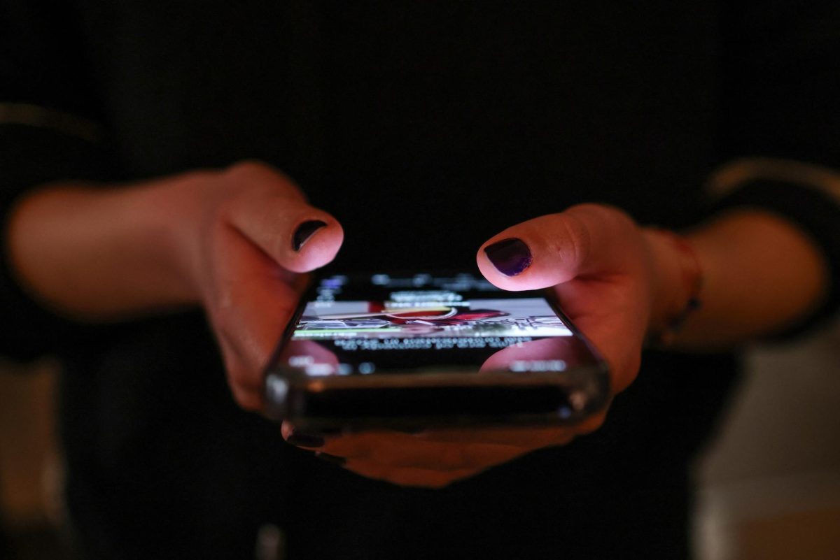 A girl checks social media posts on her phone, as Greece is set to ban under-15s from social media in European crackdown, in Athens, Greece, April 1, 2026. REUTERS/Louisa Gouliamaki