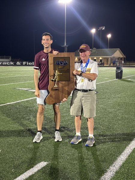 At the IHSAA State Championships on June 5 in Indianapolis, Coaches Charlie Warthan (right) and Justin Helmer hold the state championship trophy. The Cougars captured the team state title for the first time in program history.